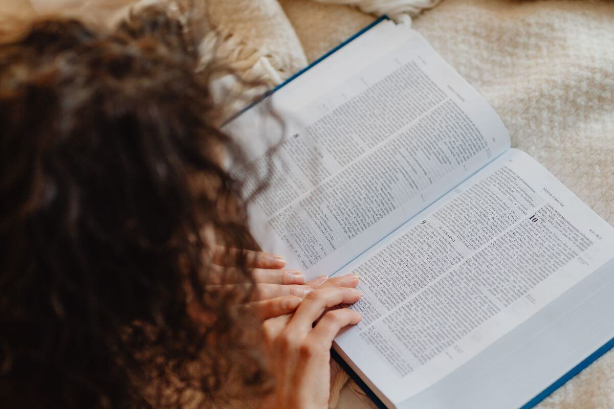 Woman reading Bible verses for sleepless nights and finding peace in God's presence