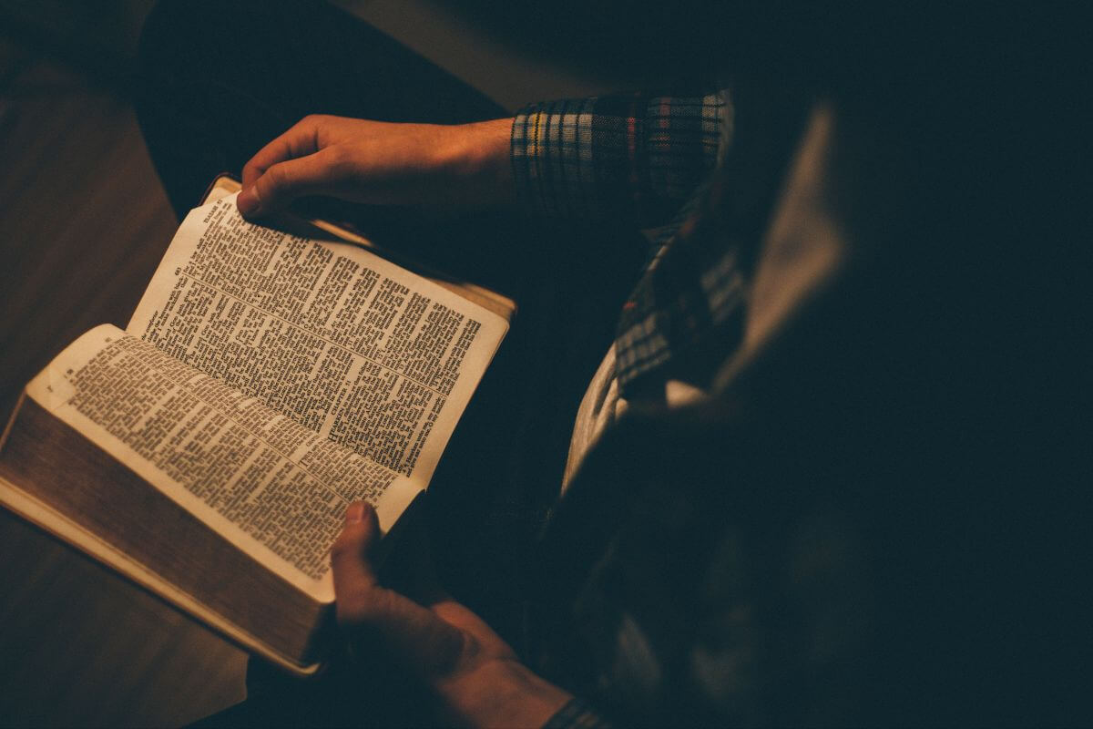 Person reading an open Bible, reflecting on God's presence and comfort during anxiety at 2 a.m.
