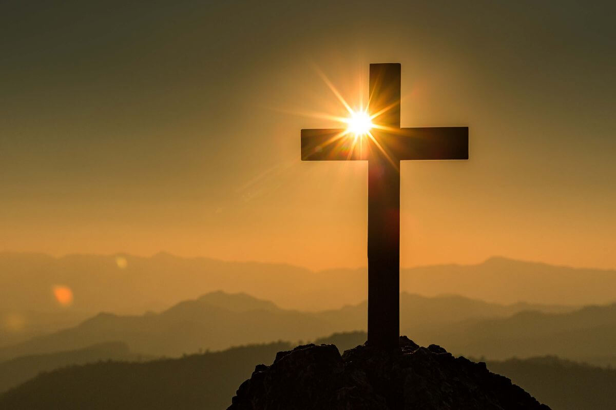 A wooden cross at sunrise, representing God's faithful presence and the hope we have as we learn to trust Him again.