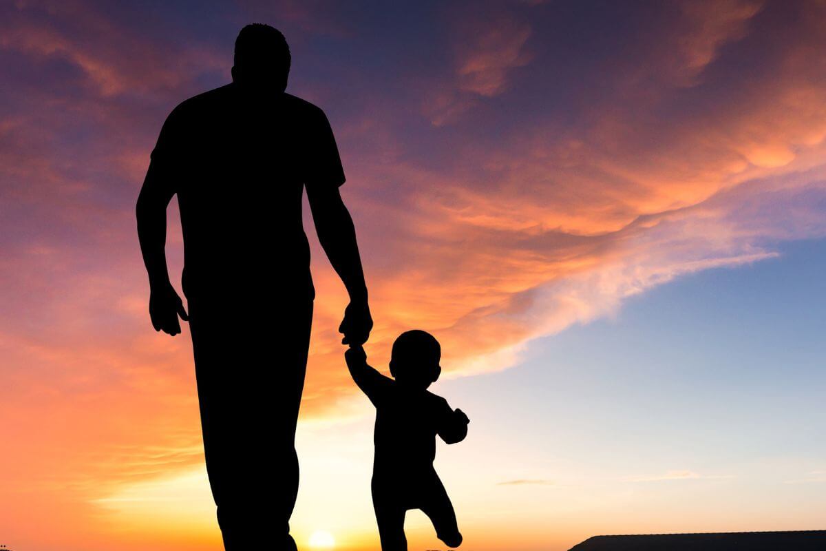 A parent holding a child's hand at sunset, symbolizing how we learn to give your worries to God as He patiently teaches our hearts to trust Him.